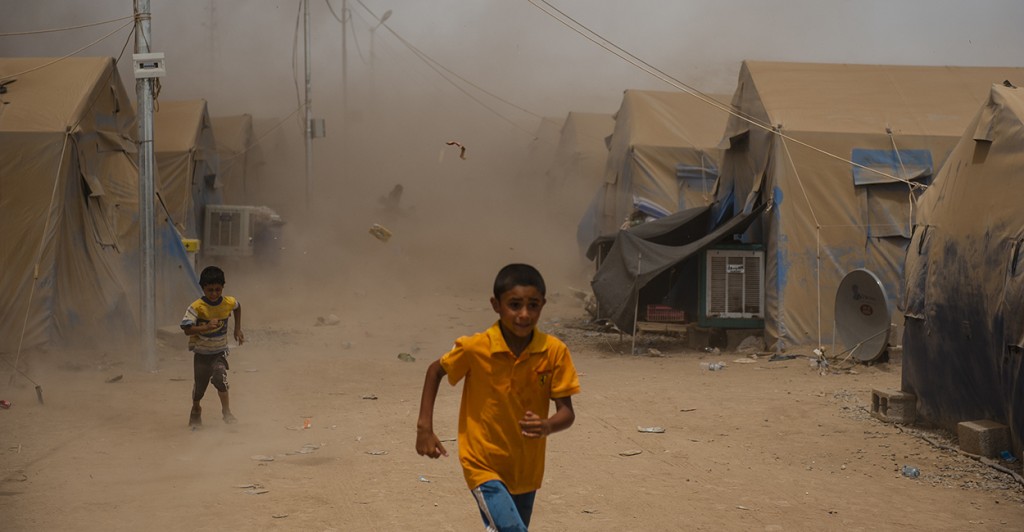 Children run as a sandstorm hits a refugee camp for those who fled the ISIS threat in Mosul, Iraq. (Photo: Martin Alan Smith/Pacific Press/Newscom)