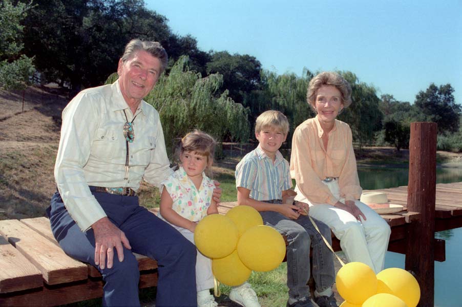 President Reagan and Nancy Reagan sitting on the dock with their grandchildren Cameron Reagan and Ashley Marie Reagan. (Photo: Ronald Reagan Library)