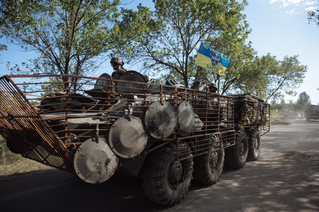 Ukrainian soldiers drive on an Armored Personnel Carrier on a road near a military camp in Kramatorsk town, near Slaviansk, Ukraine, Sept. 4, 2014. NATO and Russia set themselves on a collision course as leaders attended a summit in Wales to ramp up support from the trans-Atlantic alliance in the fight against eastern separatists, provoking angry responses from Moscow. The summit was overshadowed by Russia's annexation of Crimea in March and five months of fighting between pro-Russian separatists and government forces in eastern Ukraine. (Photo: Roman Pilipey/Newscom)