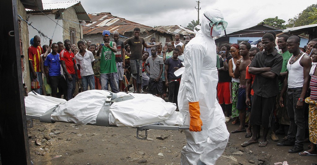 Liberian burial squad carries the body of a suspected Ebola victim. (Photo: Newscom)