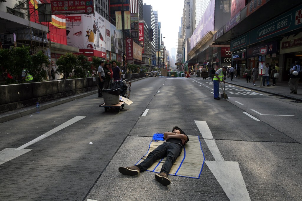 A pro-democracy protester sleeps on an occupied road during Occupy Central in Hong Kong. (Photo: Mast Irham/Newscom)