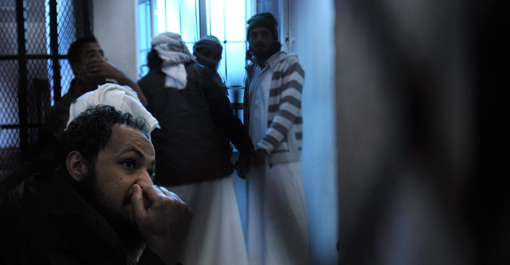 Unidentified al-Qaeda militants appear behind bars during a sentencing hearing at the state security appeal court in Sana'a, Yemen facing charges of allegedly belonging to the Al-Qaeda in the Arabian Peninsula (AQAP). (Photo: Yahya Arhab/Newscom)