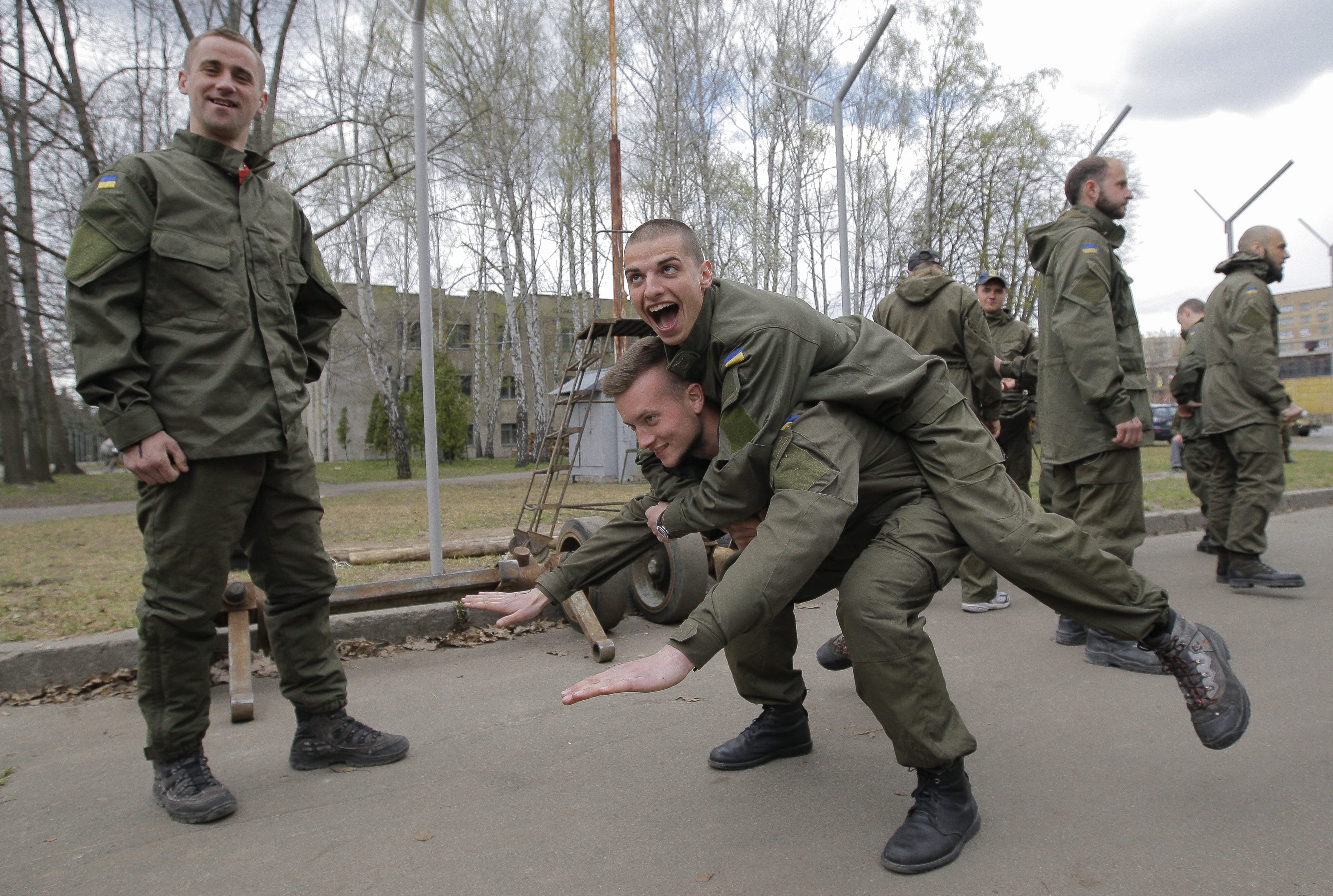 After finishing their training course, new recruits to the Ukrainian National Guard Azov Regiment goof around. (Photo: Dmitry Lipavskiy/EPA/Newscom)