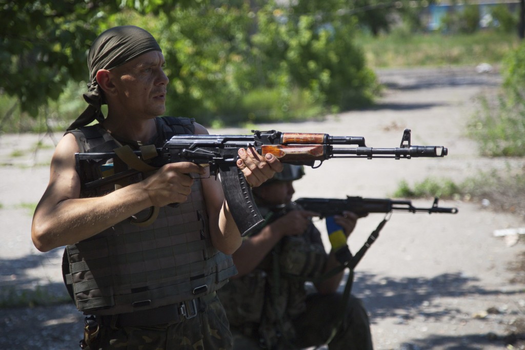 Ukrainian servicemen patrol in the town of Marinka, near Donetsk, Ukraine. (Photo: Alex Rom/EPA/Newscom)