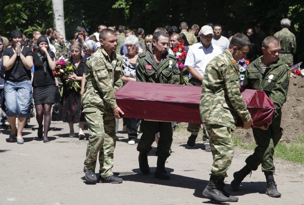 Pro-Russian rebels carry a coffin with the body of their comrade who was killed June 6 during fighting in the town of Marinka, in Donetsk, Ukraine. (Photo: Alexander Ermochenko/EPA/Newscom)