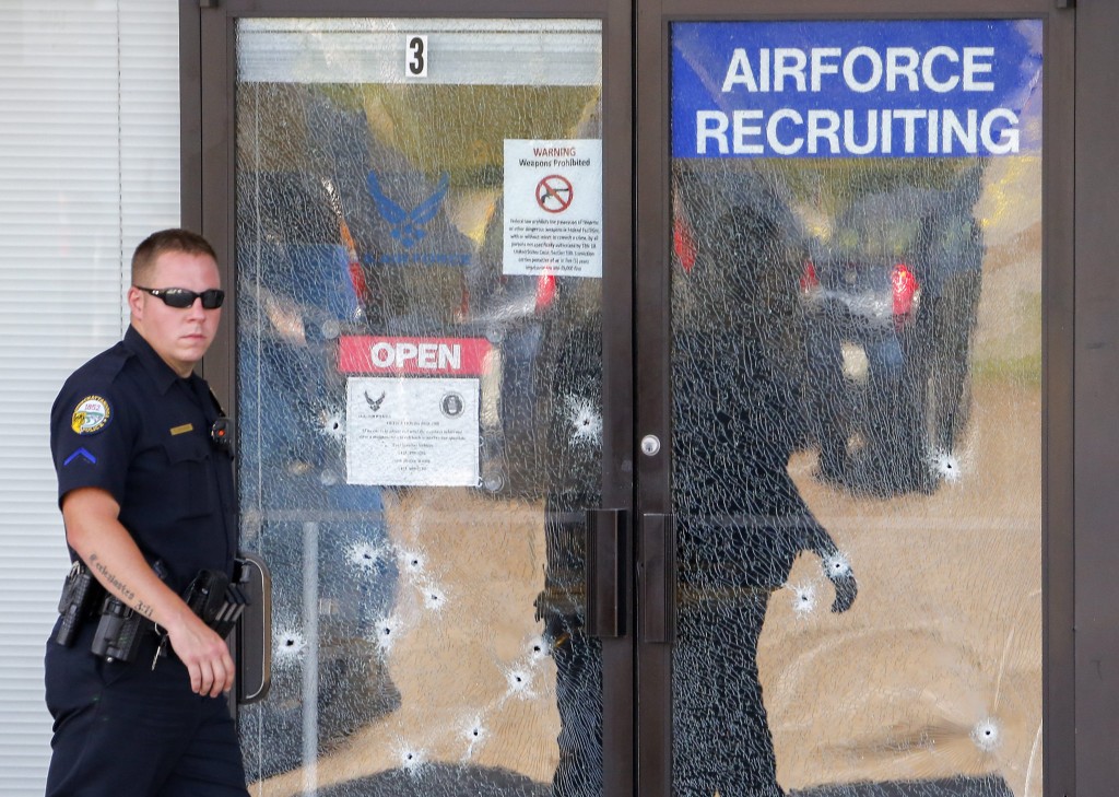 epaselect epa04849685 A Chattanooga Police officer walks past the bullet-riddled front door of a US Military Recruiting storefront after a shooting in Chattanooga, Tennessee, USA, 16 July 2015. Authorities say the shootings at two different locations left four US Marines and the gunman Mohammod Youssuf Abdulazeez dead.  EPA/ERIK S. LESSER (Newscom TagID: epalive751906.jpg) [Photo via Newscom]