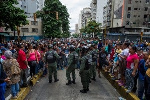 Protests against members of the Bolivarian National Guard (GNB) in downtown Caracas, Venezuela, on June 2. The protest took place over long lines and food shortages at supermarkets as Venezuela suffers from serious shortages of basic products that include sugar, milk, flour, coffee and butter. (Photo: EPA/Miguel Gutierrez/Newscom)