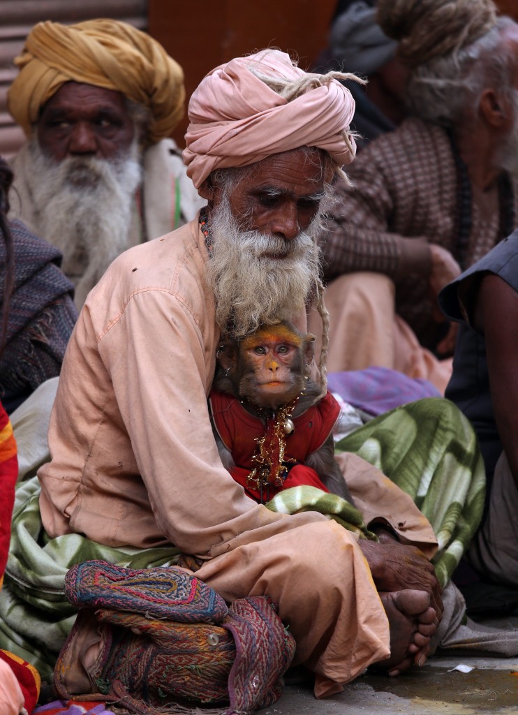 A Sadhu, or holy man, sits holding his pet monkey in his lap during a congregation of Sadhus at Diwali festival celebrations. (Photo: Newscom)