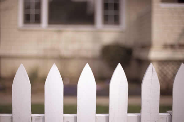 White picket fence in front of house / home