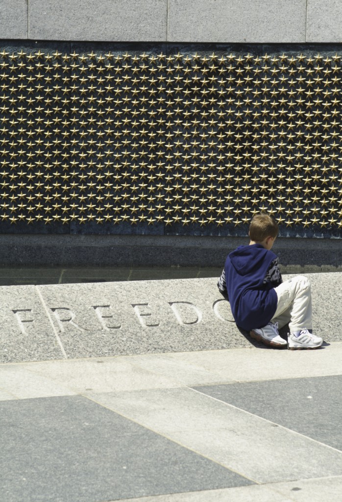 A young tourist takes in the sacrifice and honor at the memorial. (Photo: Getty Images)