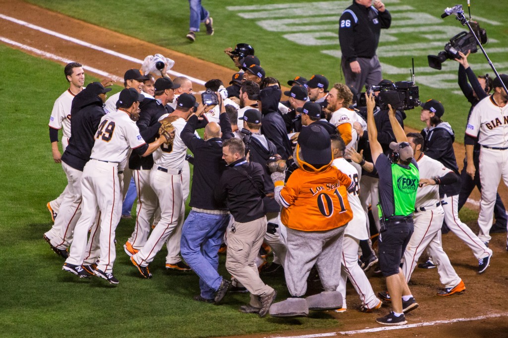 San Francisco Giants storm the field in celebration after beating the St. Louis Cardinals 6-3. (Photo: Newscom)