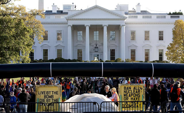 Demonstrators carry a giant mock pipeline while calling for the cancellation of the Keystone XL pipeline during a rally in front of the White House in Washington November 6, 2011.