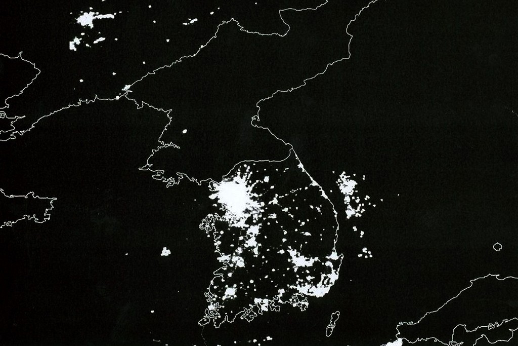 A satellite photo of the Korean Peninsula that shows the bright lights of South Korea and China compared to the blackness of North Korea at night. (Photo: Flickr)