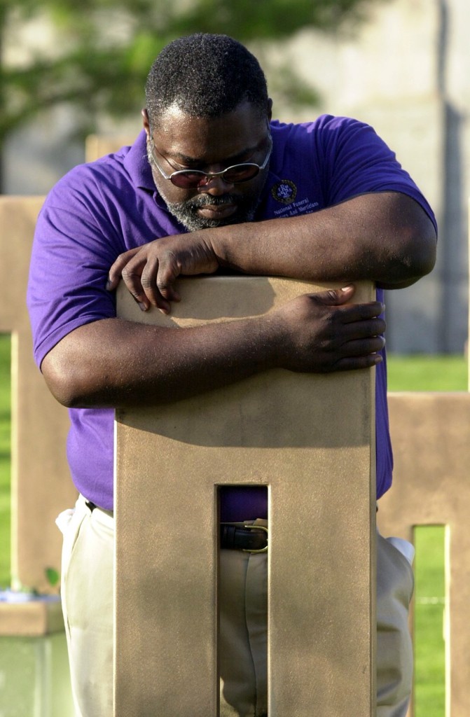 Jimmie Boldien hugs the chair of his aunt, Laura Jane Garrison, at the Oklahoma City National Memorial on Monday, June 11, 2001.  (Photo: Vert/Newscom)