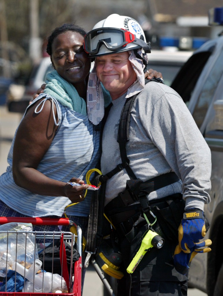 "God bless you babies," Anita Averhart said to Stan Kordecki, of St. Petersburg Fire Rescue, as firefighters searched for Hurricane Katrina survivors and bodies. (Photo: Jared Lazarus/KRT/Newscom)