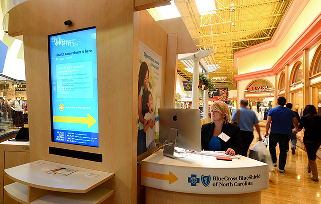 Photo: Kelli Tremblay, an authorized agent with BlueCross BlueShield of North Carolina, works a station at Concord Mills. (Photo: Jeff Siner/Charlotte Observer/MCT)
