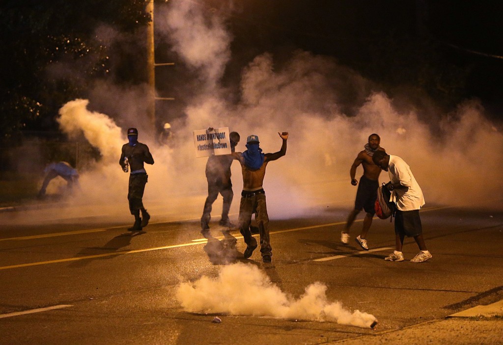 Protesters retreat as tear gas canisters detonate around them. (Photo: Chris Lee/St. Louis Post-Dispatch/MCT)