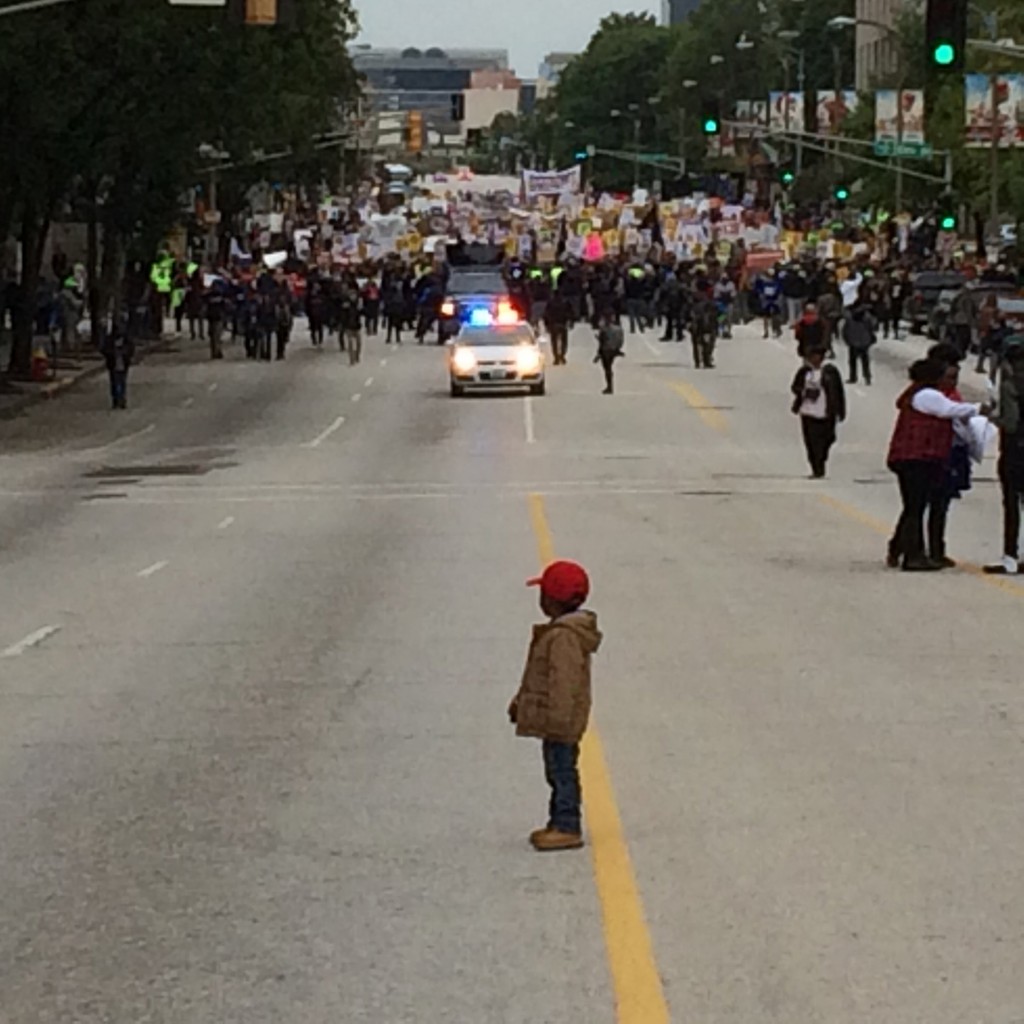 Nigel Jones-Mack, 3, waits for protesters to catch up during a Ferguson march in downtown St. Louis. He was there with family and had been trying to encourage the marchers on with a whistle and an exaggerated marching step. He stopped after getting ahead of his grandmother, Beverly Jones, who called for him to wait. (Photo: Koran Addo/St. Louis Post-Dispatch/MCT)