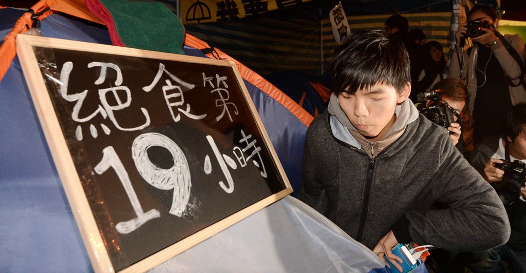 Joshua Wong, head of Hong Kong student group Scholarism, continues his indefinite hunger strike in the Admiralty district of the territory on Dec. 2, 2014. Wong, 18, along with two student members began the hunger strike the previous day to press for a second round of talks with the government over Beijing's decision on Hong Kong's upcoming leadership election. (Photo: Kyodo/Newscom)