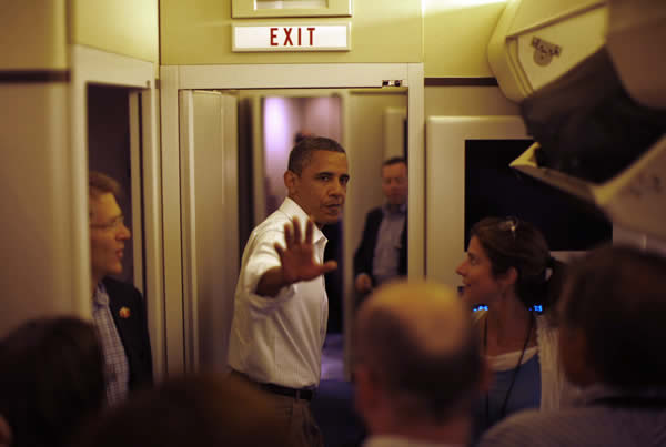 President Barack Obama gestures as he steps aboard Air Force One in Peoria August 17, 2011. 