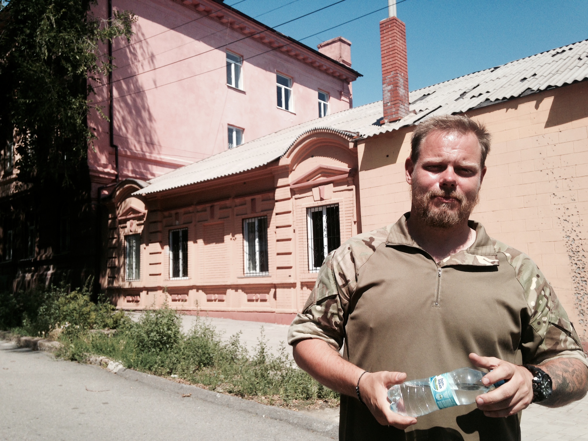 Skillt in Mariupol at the scene of his first battle. The school house and third-floor window are in the background. (Photo: Nolan Peterson/The Daily Signal)    