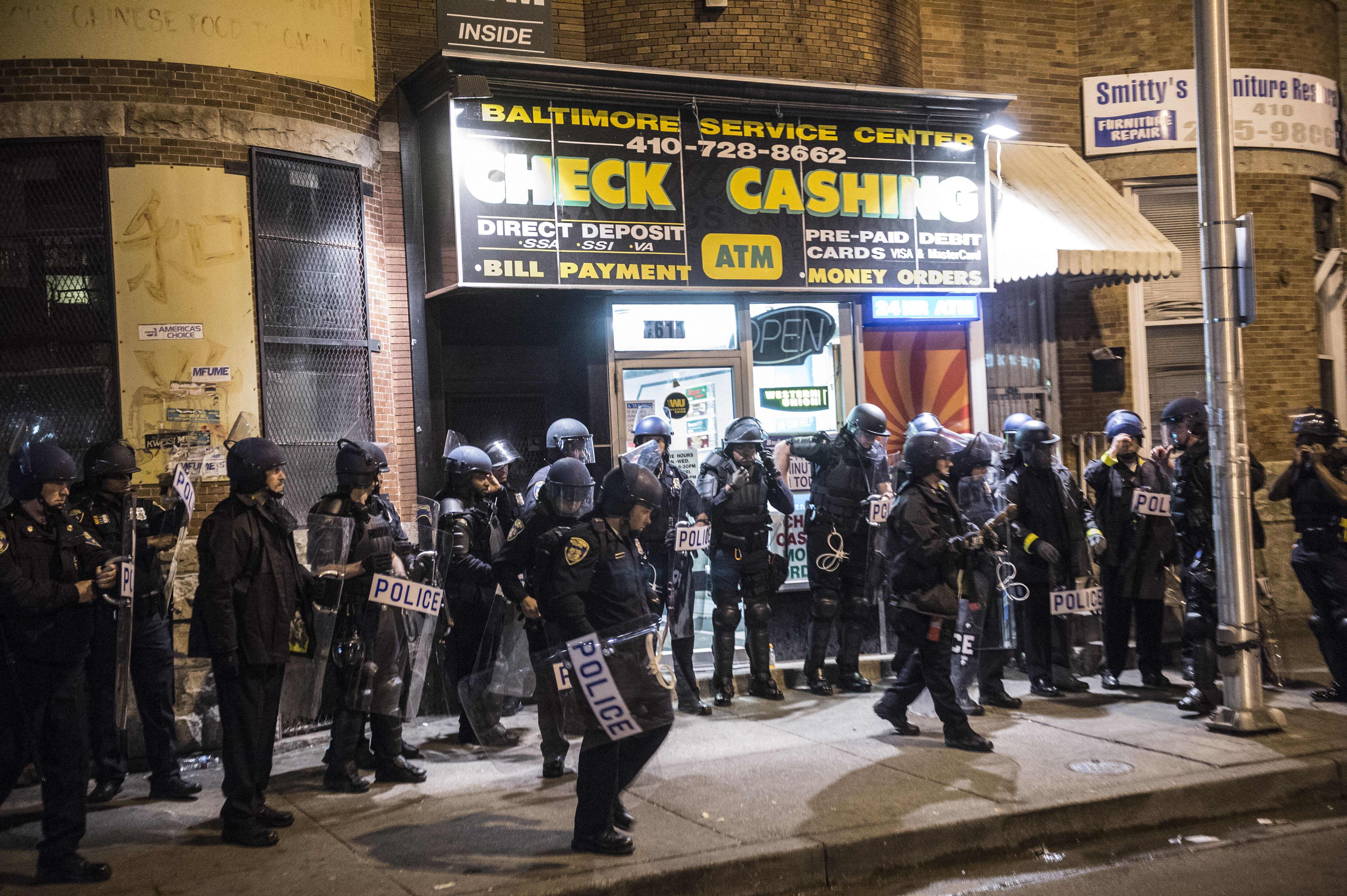 Baltimore police took to the streets at night to enforce curfew since rioting began after the funeral of Freddie Gray who died while in police custody. (Photo: Robert Stolarik/Polaris/Newscom)