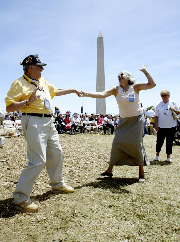 Anthony Grasso (L) from Lynnfield, Massachusetts, a botswain mate who served on the USS LST-775 in the Pacific during World War Two, dances with Tanya Wohner before the dedication ceremony for the National WW II Memorial, in Washington, May 29, 2004. (Photo: John Pryke/Newscom)