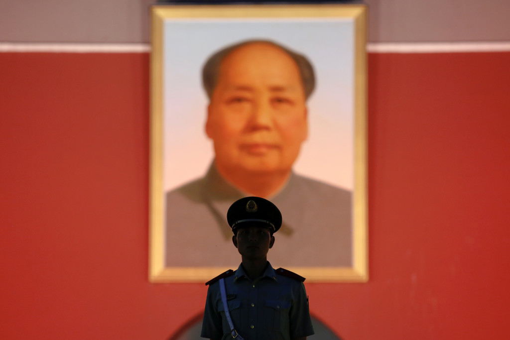 A paramilitary guard stands under a giant portrait of late Chinese Chairman Mao Zedong at the Tiananmen gate in Beijing, China June 3, 2016. (Photo: Damir Sagolj / Reuters/Newscom)