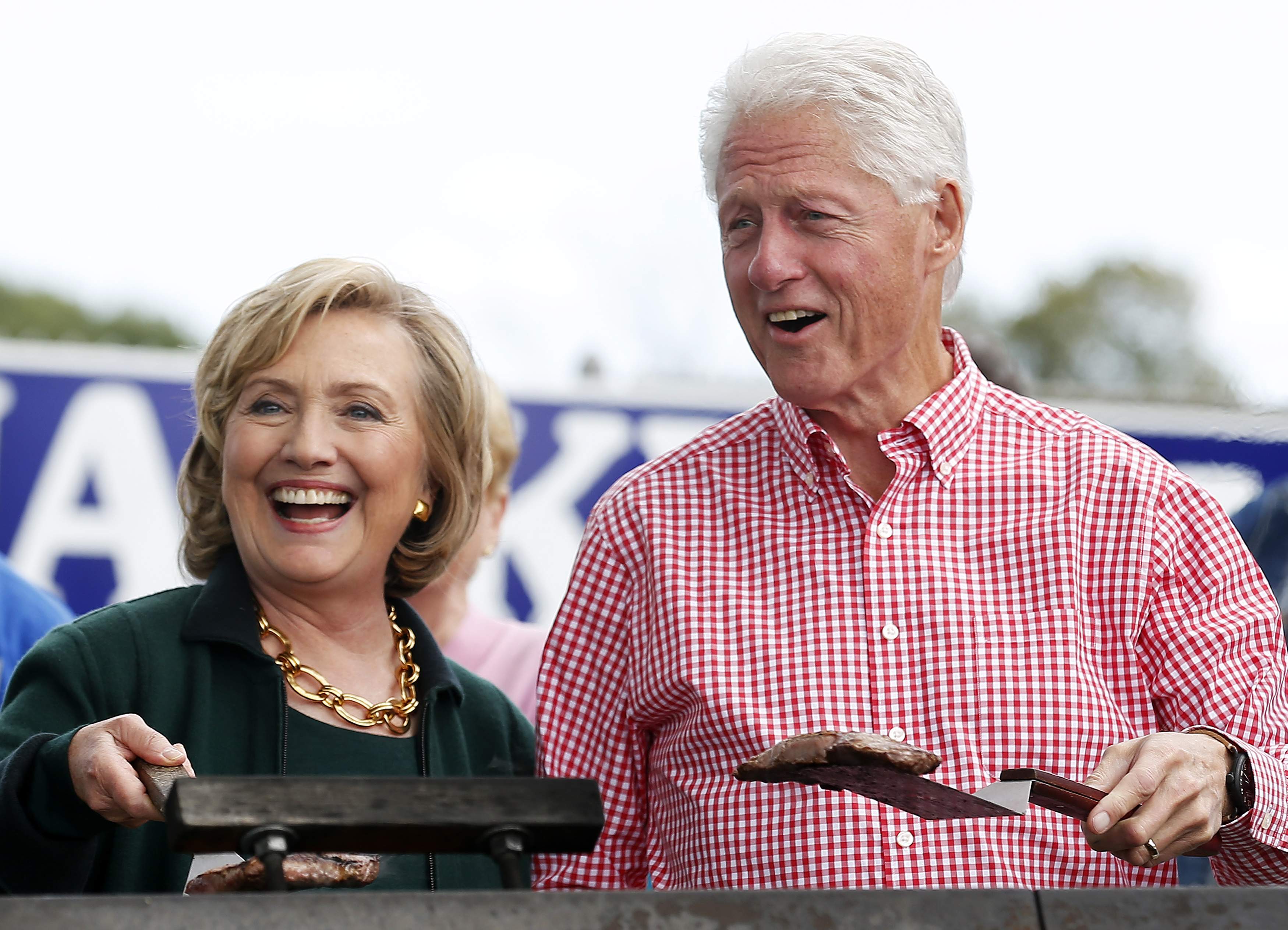 Clinton and her husband hold up some steaks at the 37th Harkin Steak Fry in Indianola, Iowa. (Photo: Jim Young/Reuters/Newscom)