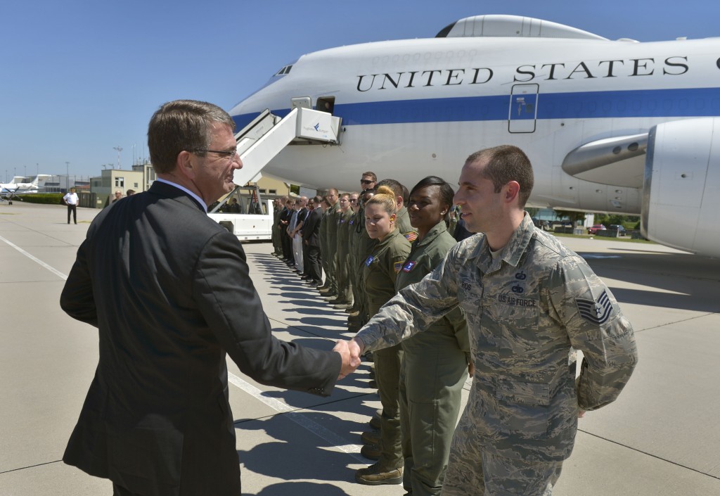 Secretary of Defense Ash Carter offers a coin and a handshake to a line of air crew personnel as he prepares to board an E4-B aircraft in Stuttgart, Germany on June 5. (Photo: Department of Defense/Sipa USA/Newscom)