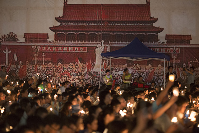 Participants hold candles during a vigil to commemorate the 25th anniversary of the Tiananmen Square crackdown in Hong Kong, China on June 4, 2014. Hong Kong is the only place on Chinese soil where large scale events to commemorate the tragic day.