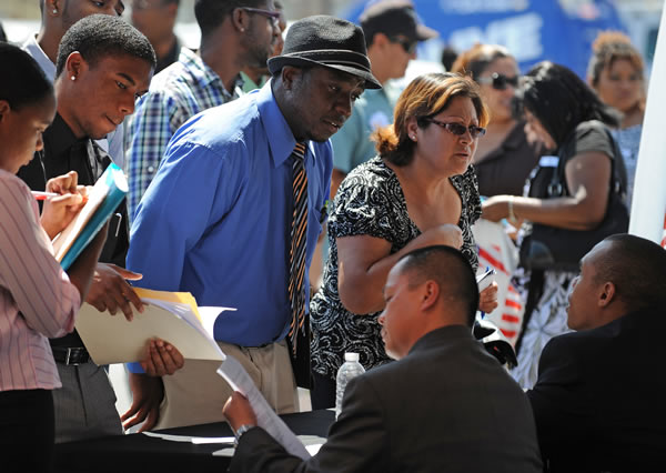 Job seekers talk to employers at a south Los Angeles job fair.