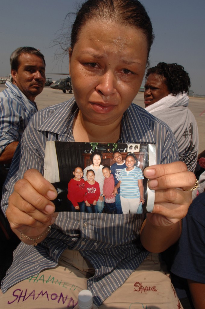 An evacuee holds a photo of her five missing children after being airlifted into New Orleans International Airport. (Photo: Staff SGT. Jacob N. Bailey/UPI Photo/USAF/Newscom) 