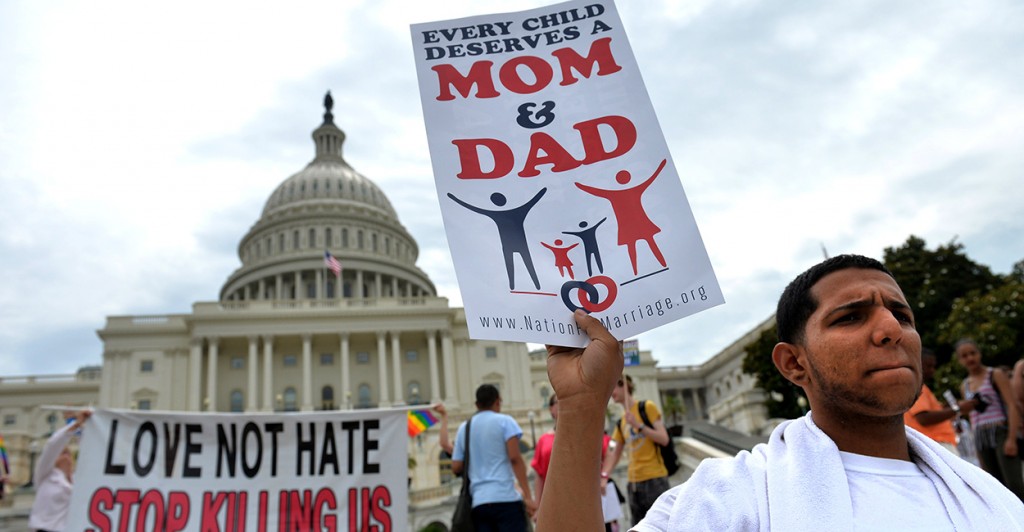 An opponent of redefining marriage makes his voice heard at the March for Marriage as activists support same-sex marriage June 19 in Washington, D.C. (Photo: UPI/Kevin Dietsch/Newscom)