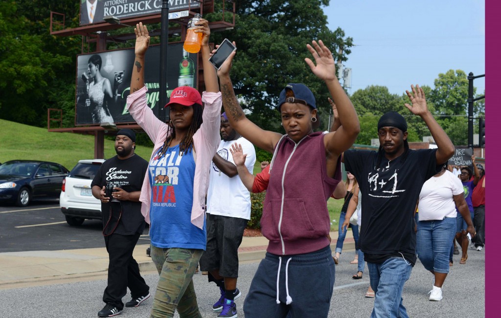 Mya White, in hat, shown in this August 11, 2014 file photo, was shot in the head during a demonstration in Ferguson, Missouri on August 13, 2014. White was shot in the head by a passing car as people demonstrated. (Photo: UPI/David Broome)