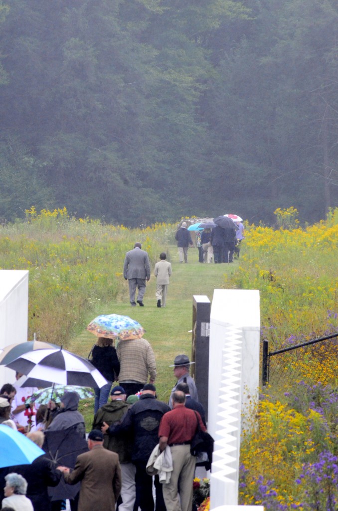 Family members of the victims of the crash of United Airline Flight 93 walks the path leading to the actual crash site at the Flight 93 National Memorial. (Photo: Newscom)