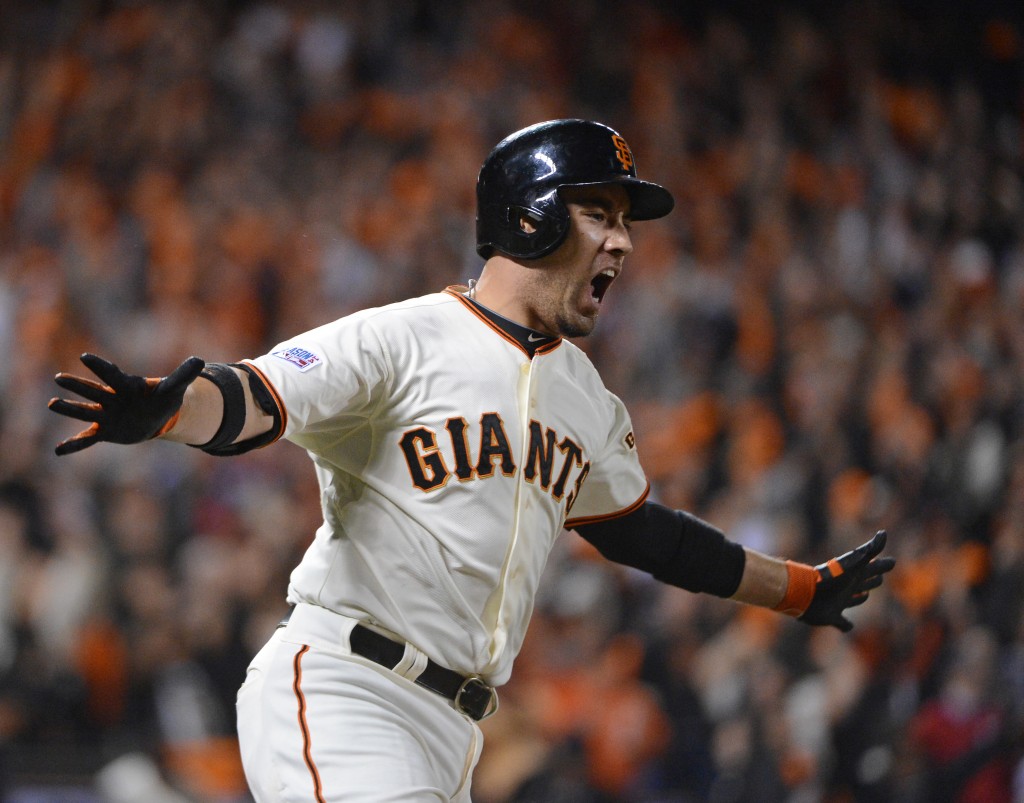 San Francisco Giants Travis Ishikawa screams as he rounds first after hitting a walk off home run in the ninth inning off St. Louis Cardinals Michael Wacha in game 5 of the National League Championship on Oct. 16. (Photo: UPI/Terry Schmitt/Newscom)