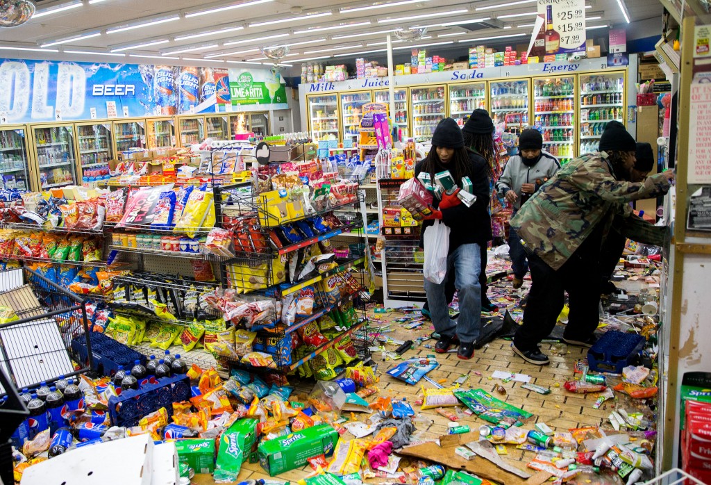 Inside a local convenience store as the looting begins. (Photo: Xinhua/Ting Shen/Newscom)