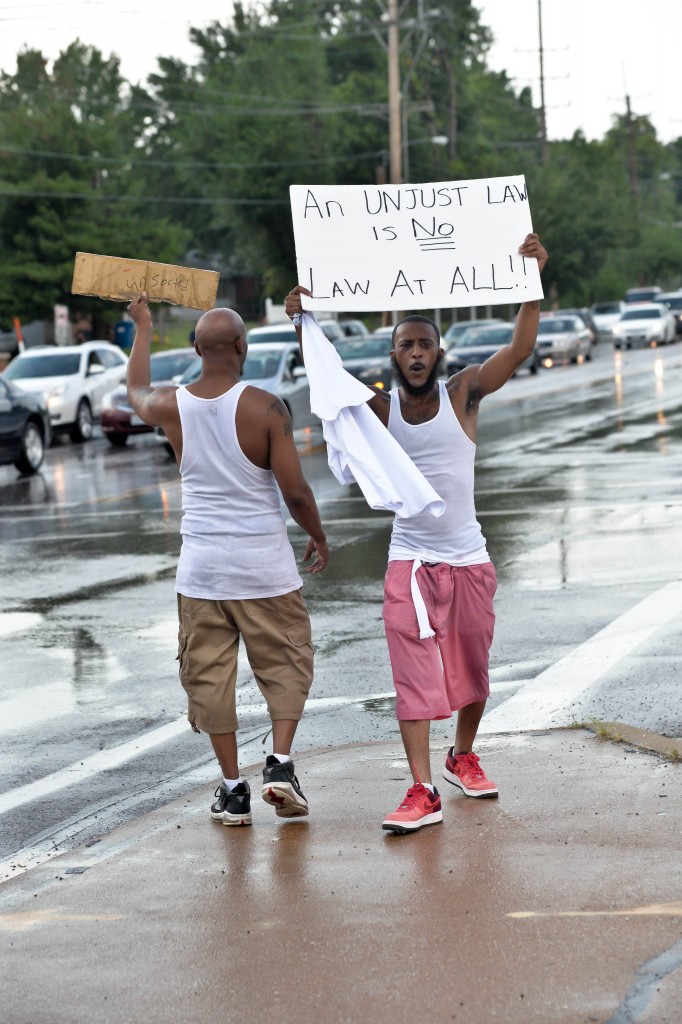 Protesters hold a peaceful demonstration of their displeasure during the second day of protests in front of the QT that was burned to ruins the night before during the riot. (Photo: Richard Ulreich/ZUMA Wire/Newscom)