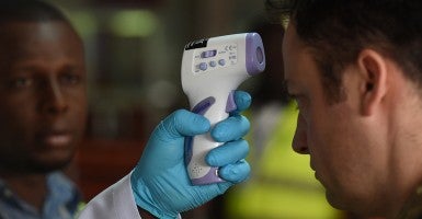 A British soldier has his temperature taken on arrival at an airport in Sierra Leone. (Photo:  Joe Giddens/PA Wire/ZumaPress.com)