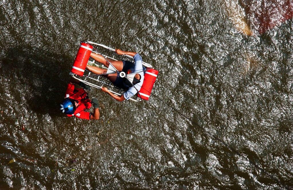 Coast Guard Petty Officer Scott Rady gives the signal to hoist a pregnant woman from her apartment. Rady is a rescue swimmer sent from Florida to help aid in search and rescue efforts in the wake of Hurricane Katrina. (Photo:NyxoLyno Cangemi/U.S. Coast Guar/ZumaPress/Newscom)