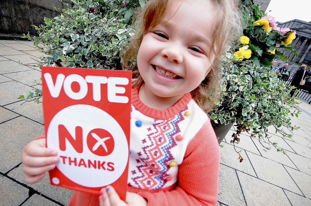 A young girl from the Better Together campaign stands next to St. James Square with ''No Thanks'' banners, stickers and placards passing out information on the vote.