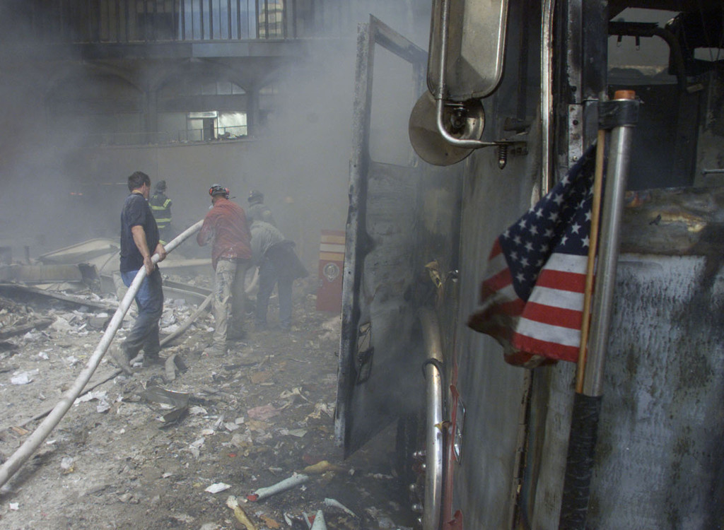 A U.S. flag flies from a burned firetruck near the wreckage. (Photo: REUTERS/Peter Morgan/Newscom) 