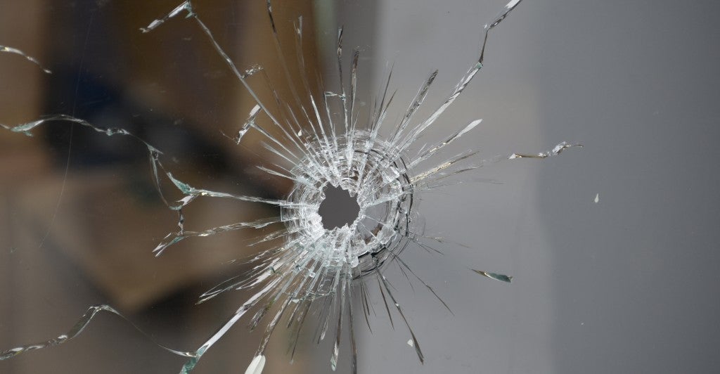 Bullet holes are seen in the glass windows where one person was killed during Friday’s tragic mass shooting and stabbing in Santa Barbara, California (Photo: Gene Blevins/ZUMAPRESS.com)