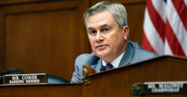 James Comer in a grey suit in front of an American flag