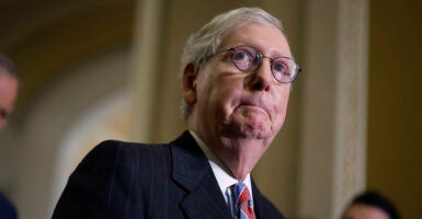 Mitch McConnell gulps in a suit