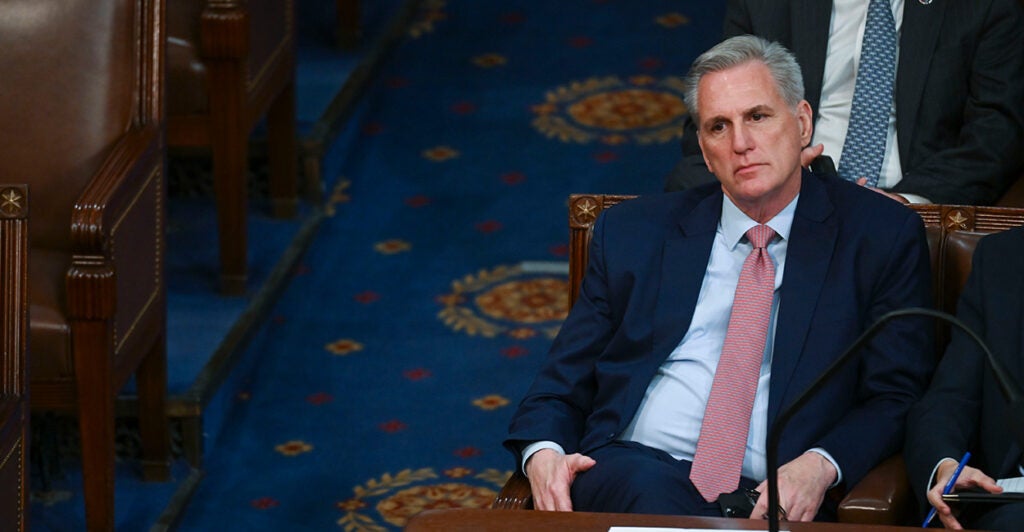 Kevin McCarthy in a black suit with a blue tie