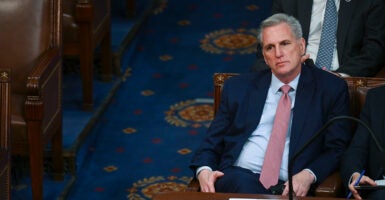 Kevin McCarthy in a black suit with a blue tie