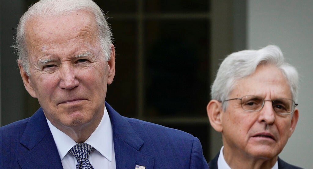 Joe Biden scowls and Merrick Garland looks suspicious