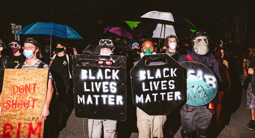 Men in masks with Black Lives Matter shields